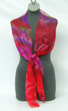 Load image into Gallery viewer, Mannequin_wearing_a_vibrant_red_and_purple_scarf_on_a_white_background_showing_a_differet_way_to_wear_a_scarf