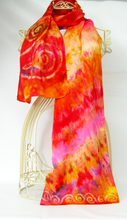Load image into Gallery viewer, a_silk_satin_scarf_luxury_satin_with_a_good_weighty_feel_draped_over_a_mannequin_against_a_white_background_in_shades_of_golden_orange_a_red