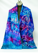 Load image into Gallery viewer, large_hand_painted_silk_scarf_in_a_blend_of_blues_greens_and_magenta_with_Celtic_design_on_one_side_of_scarf