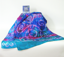 Load image into Gallery viewer, colourful_scarf_in_blues_greens_pinks_and_purples_with_a_white_background_and_the_madelocal_tag