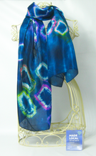Load image into Gallery viewer, A_light_weight_silk_scarf_in_a_dark_petrol_blue_tye_dye_pattern_diamond_looking_pops_of_white_and_colour_on_a_wire_mannequin_in_front_of_a_white_background_with_the_madelocal_sign