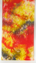 Load image into Gallery viewer, A_textile panel featuring_a_vibrant_tie-dye_and_batik_pattern_in_shades_of_red_yellow_orange_and_dark gray/black_swirls_shown_flat_agains_a_white_background.