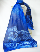 Load image into Gallery viewer, A_large_blue_shawl_with_swan_design_in_sahdes_of_blue_draped_over_a_wire_mannequin