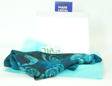 Load image into Gallery viewer, Silk_shawl_draped_on_a_white_gift_box_with_description_swing_tag_and_made_local_tag_dispalyed_in_front_of_a_white_background