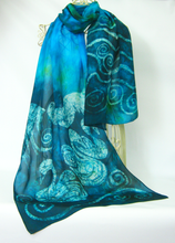 Load image into Gallery viewer, A_lightweight_teal_and_turquoise_scarf_with_white_Celtic_swirls_and_swan_design_draped_over_a_cream_wire_mannequin_against_a_white_background