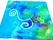Load image into Gallery viewer, A_silk_square_with_wax_drawing_of_spirals_and_a_flower_hand_painted_in_the_art_of_batik_in_shades_of_turquoise_blue_and_green