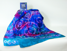 Load image into Gallery viewer, silk_scarf_hand_painted_with_a_celtic_design_draped_on_table_with_madelocal_sign

