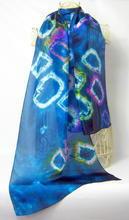 Load image into Gallery viewer, A_hand_painted_silk_scarf_in_dark_blue_with_tie_dye_design_with_whites_pinks_yellows_purple_and_orange_draped_over_a_cream_coloured_mannequin_infront_of_a_white_wall_perfect_big_birthday_gift_ideas
