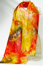 Load image into Gallery viewer, silk_scarf_with_vibrant_tie_dye_and_batik_art_design_of_the_little_gold_finch_draped_over_a_wire_mannequinn_infront_of_a_white_background
