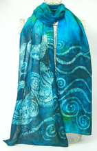 Load image into Gallery viewer, A_large_hand_painted_silk_shawl_draped_over_a_cream_coloured_mannequinn_with_batik_painting_of_swans_and_celtic_spirals
