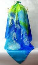 Load image into Gallery viewer, hand_painted_silk_square_scarf_in_bright_shades_of_blue_and_turquoise_with_The_Children_of_Lir_design
