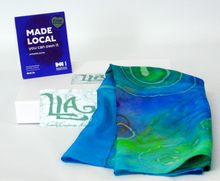 Load image into Gallery viewer, silk_square_folded_and_draped_on_a_white_gift_bag_with_the_madelocal_sign_on_top
