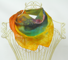 Load image into Gallery viewer, The_silk_bandana_dispalyed_around_the_neck_of_the_wire_mannequin_In_warm_shades_of_golden_yellow_with_hints_of_green_and_purple_with_swirly_branches_in_Celtic_spirals

